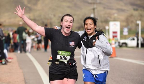 Two happy female 5k runners celebrating