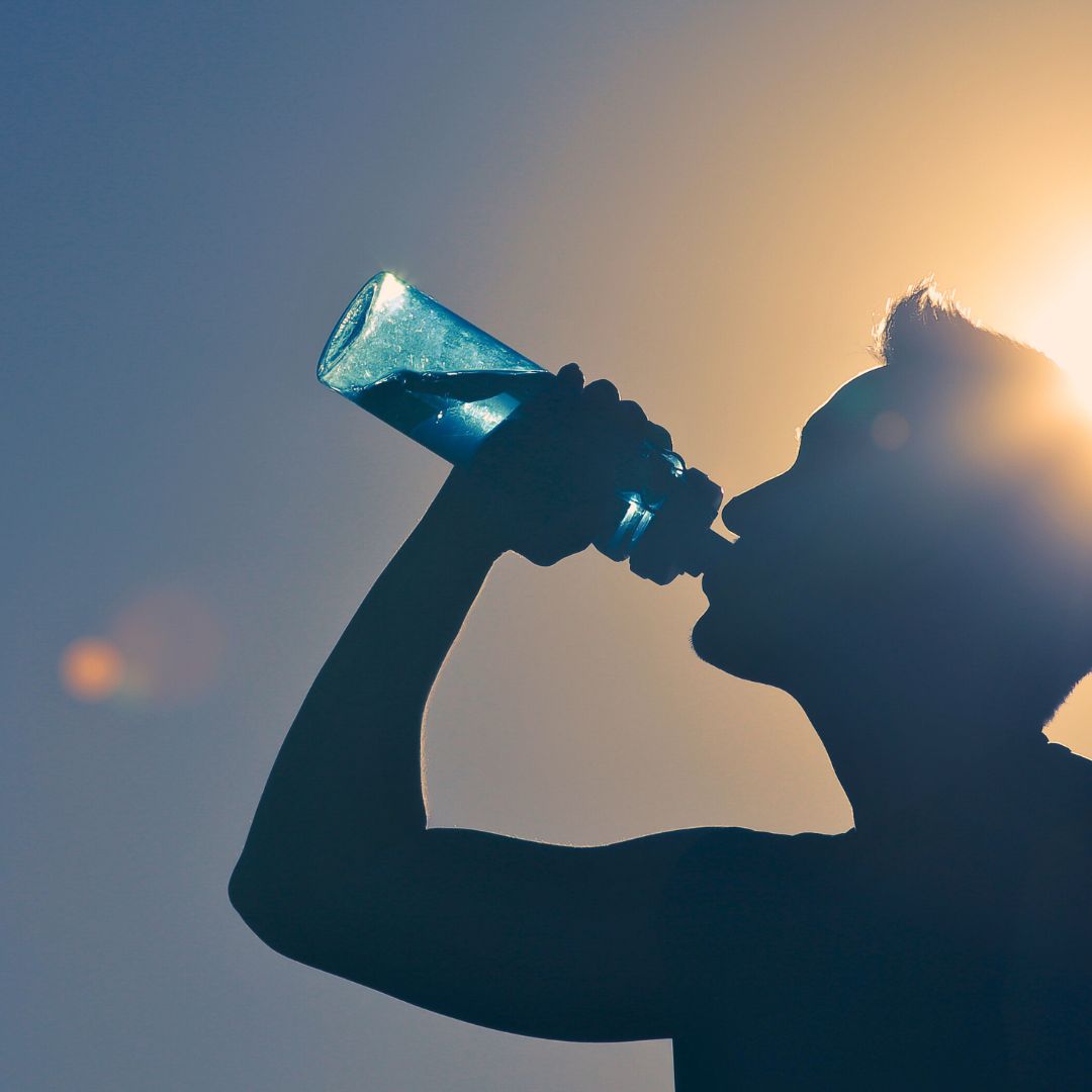 Male runner drinking a bottle of water