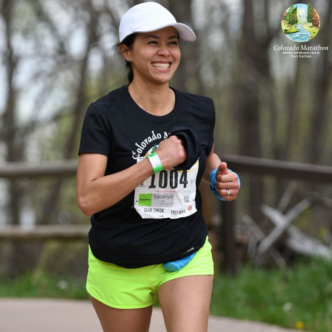 Smiling female marathon participant running at high altitude during the Colorado Marathon